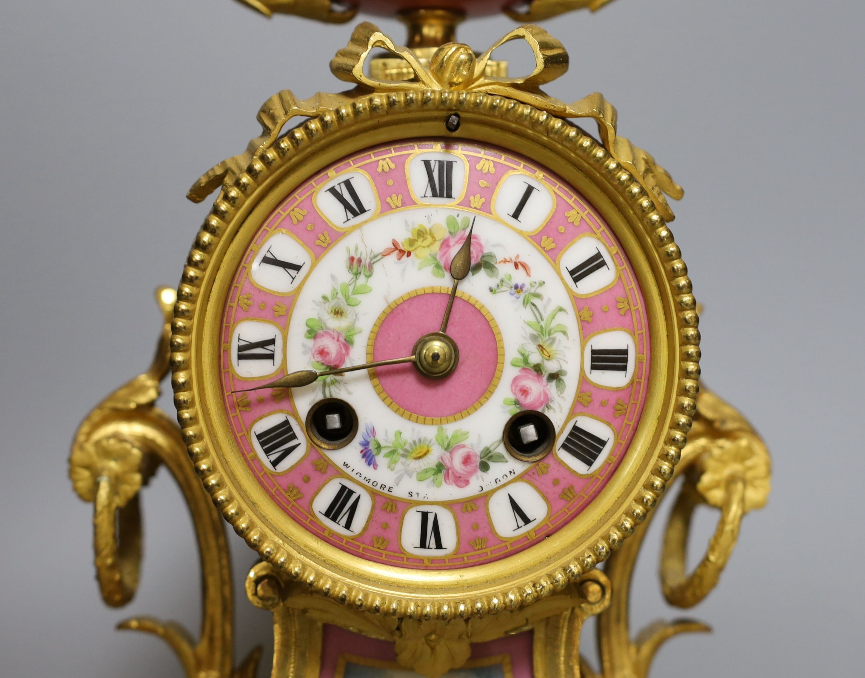 A French ormolu mantel clock with Sevres style panels. Height 29cm